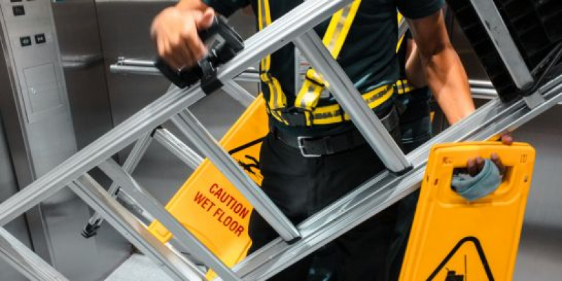 Worker following ladder safety protocols